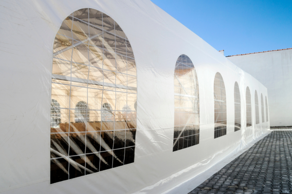 White party tent outdoors set up on a clear day